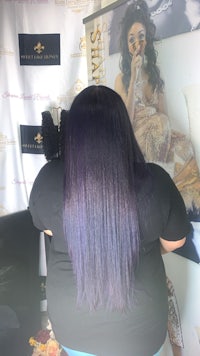 the back of a woman with purple hair